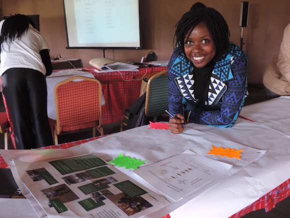 Emily Ongus one of the YPARD face to face mentees jotting down her achievements.